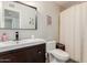 Bathroom featuring dark wood vanity, a modern sink, and a shower behind a curtain at 808 N 78Th St, Scottsdale, AZ 85257