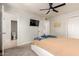 Spacious bedroom featuring a ceiling fan, mounted TV, and an ensuite bathroom entrance at 808 N 78Th St, Scottsdale, AZ 85257