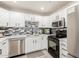 Bright kitchen with white cabinetry, stainless appliances, and a mosaic backsplash at 808 N 78Th St, Scottsdale, AZ 85257