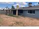 Backyard view of covered patio, mature trees, and block fencing at 836 W Laguna Azul Ave, Mesa, AZ 85210
