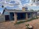 Exterior of home featuring a covered patio, mature trees, and block fencing at 836 W Laguna Azul Ave, Mesa, AZ 85210
