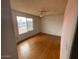 Bright bedroom featuring a ceiling fan, a large window and wood-look floors at 836 W Laguna Azul Ave, Mesa, AZ 85210