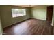 Bedroom featuring laminate wood floors and a large window at 836 W Laguna Azul Ave, Mesa, AZ 85210