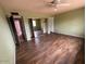 Spacious bedroom featuring wood floors, ceiling fan, and a closet with sliding mirror doors at 836 W Laguna Azul Ave, Mesa, AZ 85210