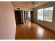 Bedroom featuring pink walls, wood-look floors, and a large window at 836 W Laguna Azul Ave, Mesa, AZ 85210