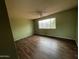 Bedroom boasting wood-look floors and a large window offering plenty of natural light at 836 W Laguna Azul Ave, Mesa, AZ 85210