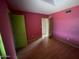 Small bedroom featuring pink walls, wood-look floors, and a door to a closet space at 836 W Laguna Azul Ave, Mesa, AZ 85210