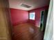 Small bedroom featuring pink walls and wood-look floors at 836 W Laguna Azul Ave, Mesa, AZ 85210