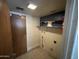 Small laundry room with door, shelf and tile floor at 836 W Laguna Azul Ave, Mesa, AZ 85210