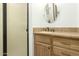 Bathroom featuring wood vanity with granite countertop, oval mirror, and enclosed shower at 8717 W Turney Ave, Phoenix, AZ 85037