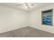 Bedroom with a window view offering natural light and a ceiling fan overhead at 8717 W Turney Ave, Phoenix, AZ 85037