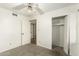 Bright bedroom featuring carpeted floors, closet, and direct access to another room at 8717 W Turney Ave, Phoenix, AZ 85037