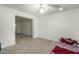 Neutral bedroom featuring carpeted floors, a ceiling fan and an opening to the next room at 8717 W Turney Ave, Phoenix, AZ 85037