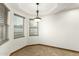 Well-lit dining room featuring tiled floors and natural light from two windows at 8717 W Turney Ave, Phoenix, AZ 85037