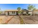 Charming single-story home with desert landscaping and a brick walkway leading to the front door at 8717 W Turney Ave, Phoenix, AZ 85037