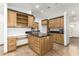 Kitchen featuring wood cabinets with black countertops and an island with storage at 8717 W Turney Ave, Phoenix, AZ 85037