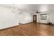 Spacious living room featuring hardwood floors, a ceiling fan, and a classic chandelier at 8717 W Turney Ave, Phoenix, AZ 85037