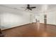 Spacious living room featuring hardwood floors, a ceiling fan, and a classic chandelier at 8717 W Turney Ave, Phoenix, AZ 85037