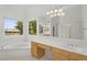 Bright bathroom featuring a garden tub, dual sinks, and a large window providing natural light at 8754 W Karen Lee Ln, Peoria, AZ 85382