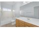 Bright bathroom featuring a tub, shower, toilet, and vanity with a large mirror at 8754 W Karen Lee Ln, Peoria, AZ 85382