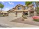 Charming two-story home with a three-car garage, desert landscaping, and a tile roof at 8754 W Karen Lee Ln, Peoria, AZ 85382