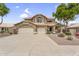 Charming two-story home with a three-car garage, desert landscaping, and a tile roof at 8754 W Karen Lee Ln, Peoria, AZ 85382