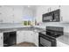 Bright kitchen with white cabinets, grey countertops and black appliances at 8754 W Karen Lee Ln, Peoria, AZ 85382