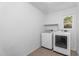 Bright laundry room featuring a washer and dryer set and a window at 8754 W Karen Lee Ln, Peoria, AZ 85382