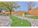 Backyard mini golf course with artificial turf, stone features, and desert plants, perfect for recreation at 8930 W Sells Dr, Phoenix, AZ 85037