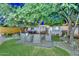 Charming backyard oasis with lush lawn, comfortable seating, mature trees and string lights at 8930 W Sells Dr, Phoenix, AZ 85037