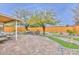 Spacious backyard with a putting green, seating area, and covered patio providing outdoor entertaining options at 8930 W Sells Dr, Phoenix, AZ 85037