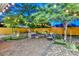 Well designed backyard with stylish seating area, artificial turf, and trees with string lights at 8930 W Sells Dr, Phoenix, AZ 85037