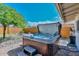 Backyard view featuring a hot tub, hardscape, and mature landscaping at 8930 W Sells Dr, Phoenix, AZ 85037