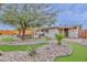 Spacious backyard with a unique miniature golf course, rock garden, and patio area for entertaining at 8930 W Sells Dr, Phoenix, AZ 85037