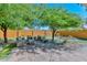 Outdoor living space with a seating area, a putting green and mature landscaping at 8930 W Sells Dr, Phoenix, AZ 85037