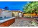 Relaxing backyard featuring a hot tub, barbecue grill, covered patio, and stone landscaping at 8930 W Sells Dr, Phoenix, AZ 85037