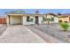 Attractive single-story home featuring solar panels, desert landscaping, and a covered parking area at 8930 W Sells Dr, Phoenix, AZ 85037