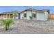 Inviting single-story home with desert landscaping, solar panels, and a quaint covered entryway at 8930 W Sells Dr, Phoenix, AZ 85037