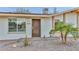 Close up of a single-story home featuring desert landscaping, solar panels, and a quaint covered entryway at 8930 W Sells Dr, Phoenix, AZ 85037