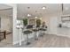An inviting kitchen bar area with pendant lighting, barstool seating, and easy access to adjacent rooms at 8930 W Sells Dr, Phoenix, AZ 85037