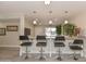 Charming kitchen bar with stylish pendant lights and barstools, great for casual dining and entertaining at 8930 W Sells Dr, Phoenix, AZ 85037