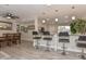 Bright kitchen with granite counters, island bar, stainless steel appliances, and light wood flooring at 8930 W Sells Dr, Phoenix, AZ 85037