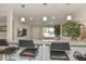 Bright open kitchen with granite counters, an island bar with pendant lights, and a view of the living area at 8930 W Sells Dr, Phoenix, AZ 85037