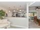 An open-concept kitchen featuring a breakfast bar with pendant lights, a seating area, and an adjacent dining space at 8930 W Sells Dr, Phoenix, AZ 85037