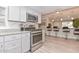 Well-lit kitchen featuring stainless steel appliances, granite counters, and modern gray cabinetry at 8930 W Sells Dr, Phoenix, AZ 85037