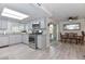 Bright, remodeled kitchen with granite counters, gray cabinets, stainless appliances, and an open layout to the dining area at 8930 W Sells Dr, Phoenix, AZ 85037