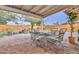 Covered patio features a dining area, seating area, and brick flooring for outdoor living at 8930 W Sells Dr, Phoenix, AZ 85037