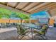 Inviting covered patio features a dining area, seating area, and access to a hot tub for relaxation at 8930 W Sells Dr, Phoenix, AZ 85037