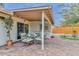 Covered patio boasts a dining area, sliding glass doors, and views of the landscaped backyard at 8930 W Sells Dr, Phoenix, AZ 85037