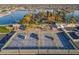 Aerial view featuring tennis courts, lake, and community amenities at 10072 W Lancaster Dr, Sun City, AZ 85351